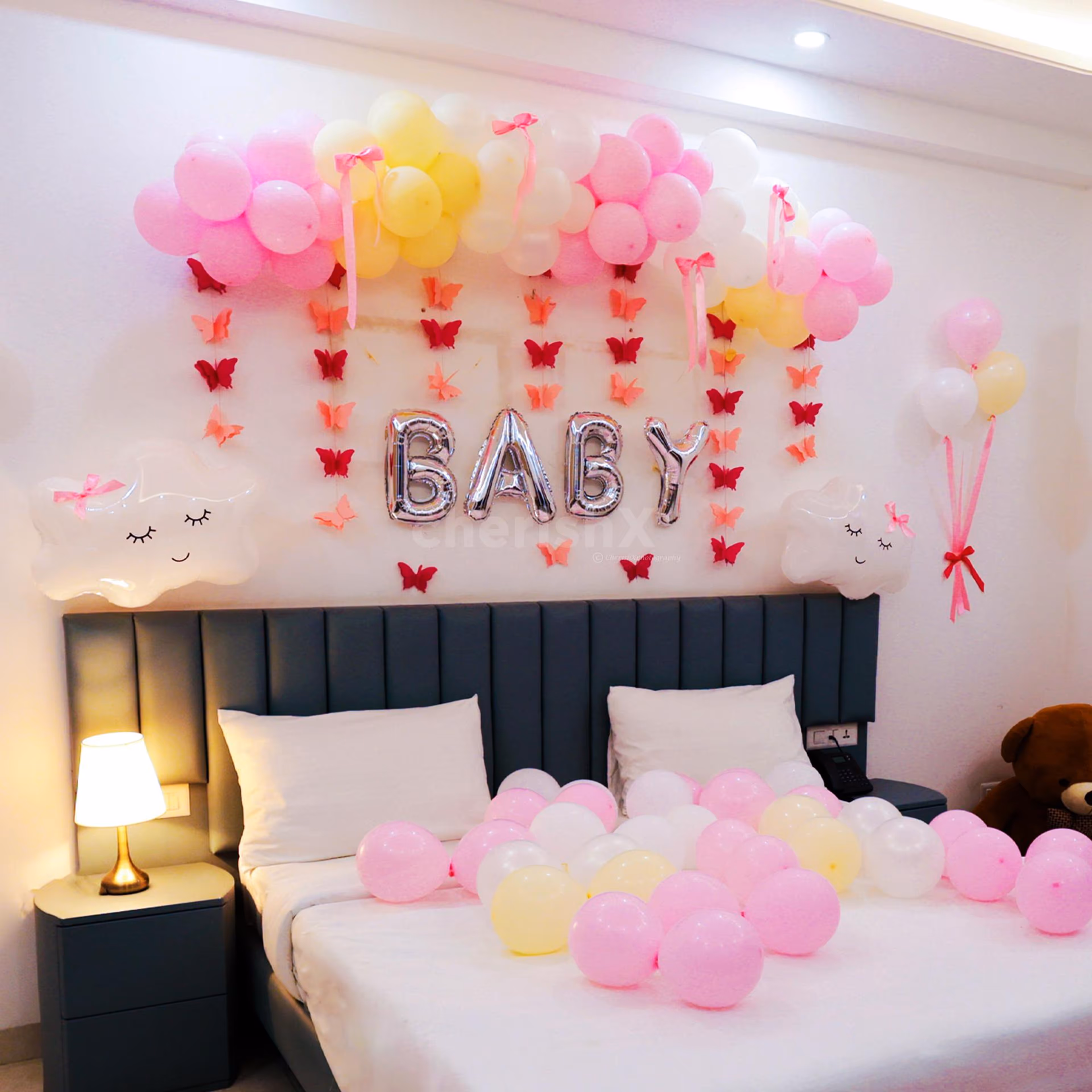 Bows and cloud-shaped balloons create a floating, fairy-like appearance.