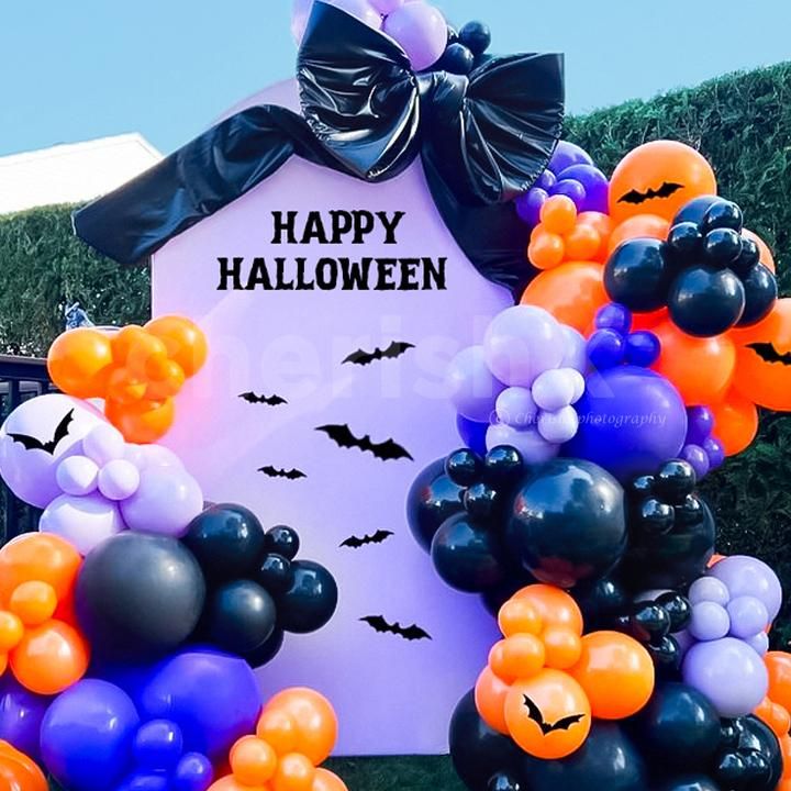 Celebrate Halloween in grand style with a bold balloon and bat backdrop.