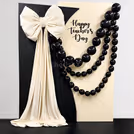 Photo-ready black balloons and sunboard cutouts make a colorful backdrop