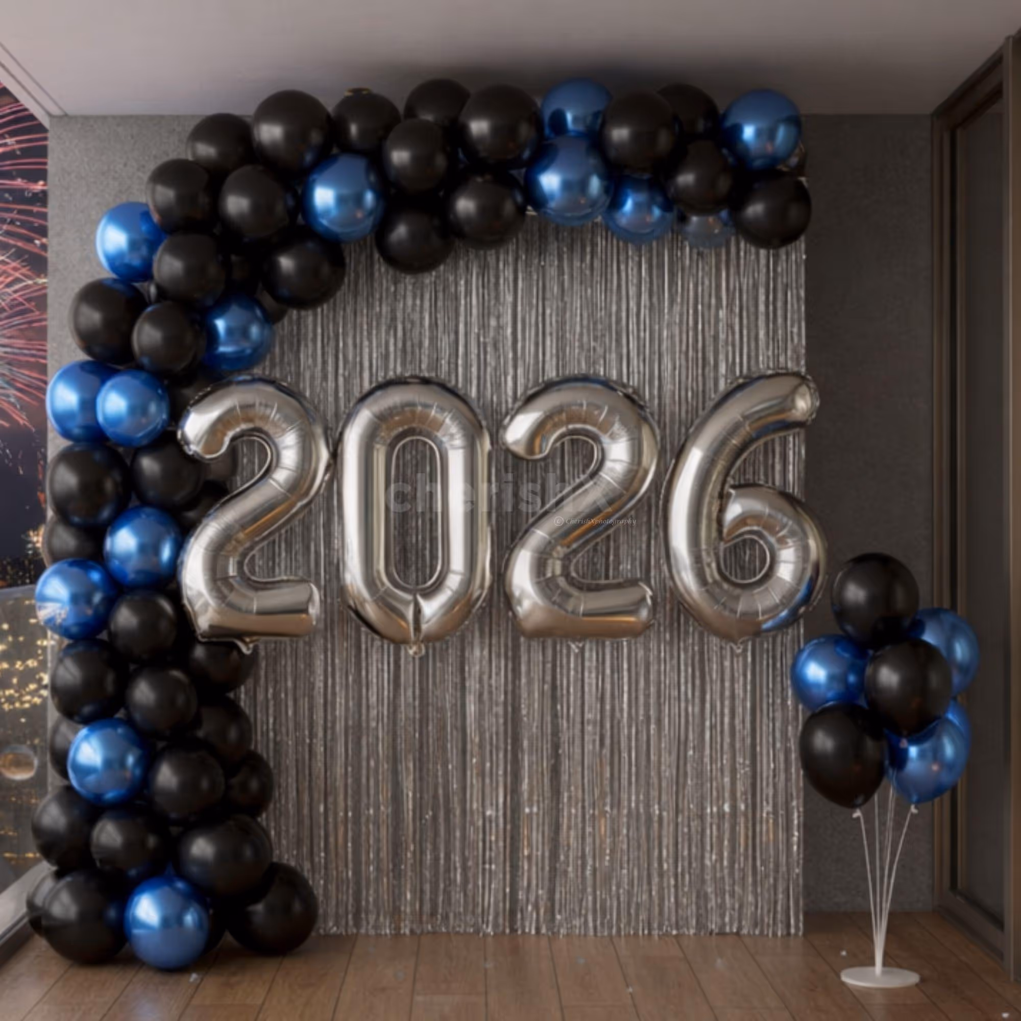 Balloon stand and sticks complement the wall decor with a ground-level balloon cluster