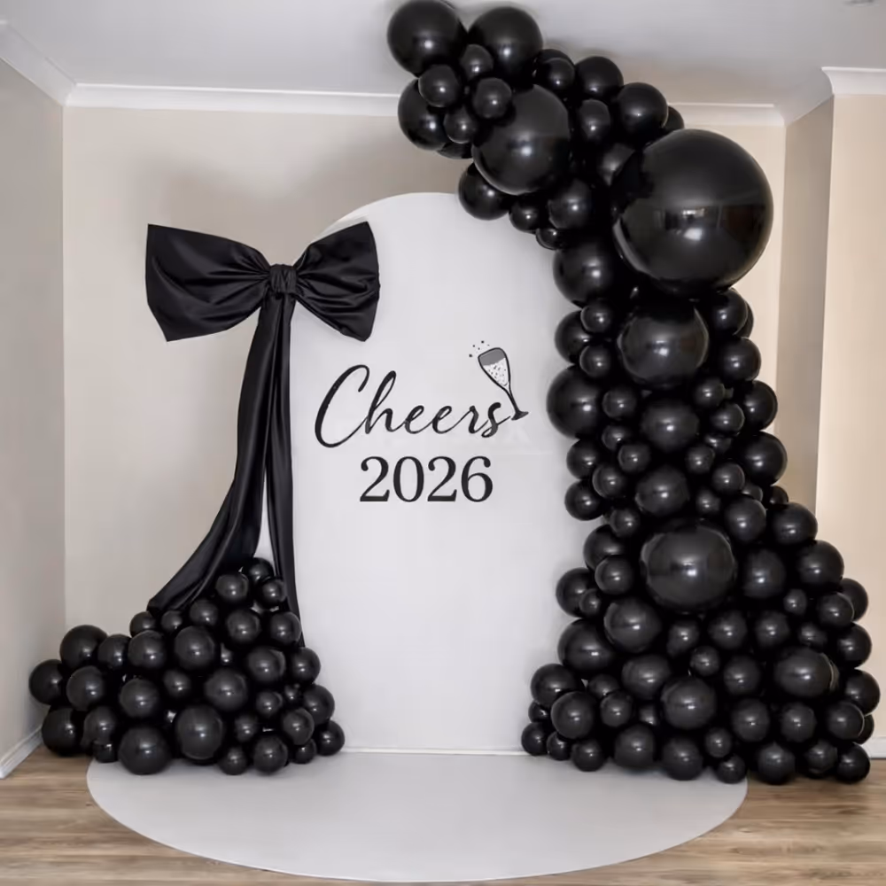 The oversized black bow at the sunboard's top corner adds a dramatic twist to the decoration.