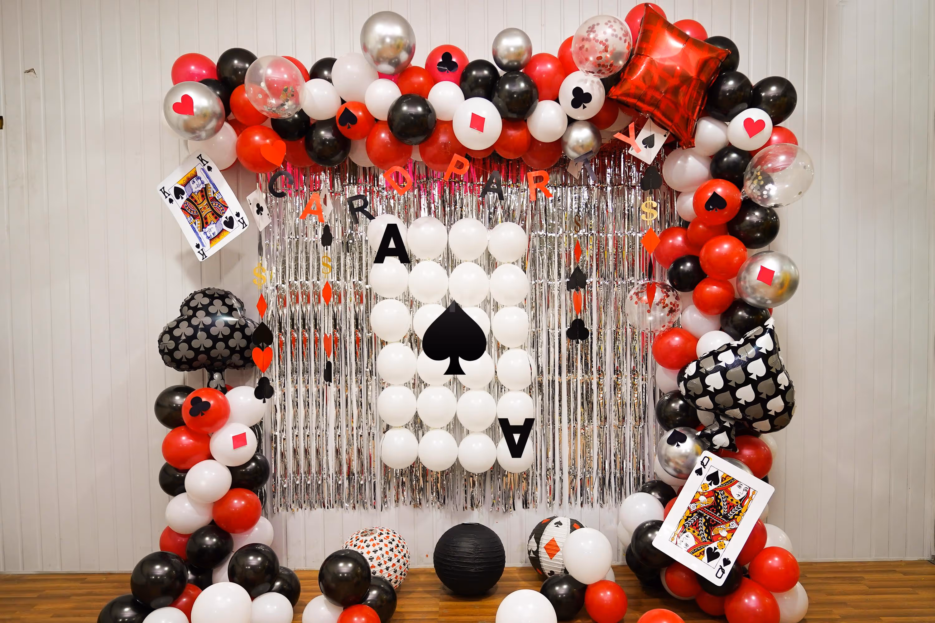 Elegant Casino-Themed Balloon Arch in Black, Red, and White Balloons.
