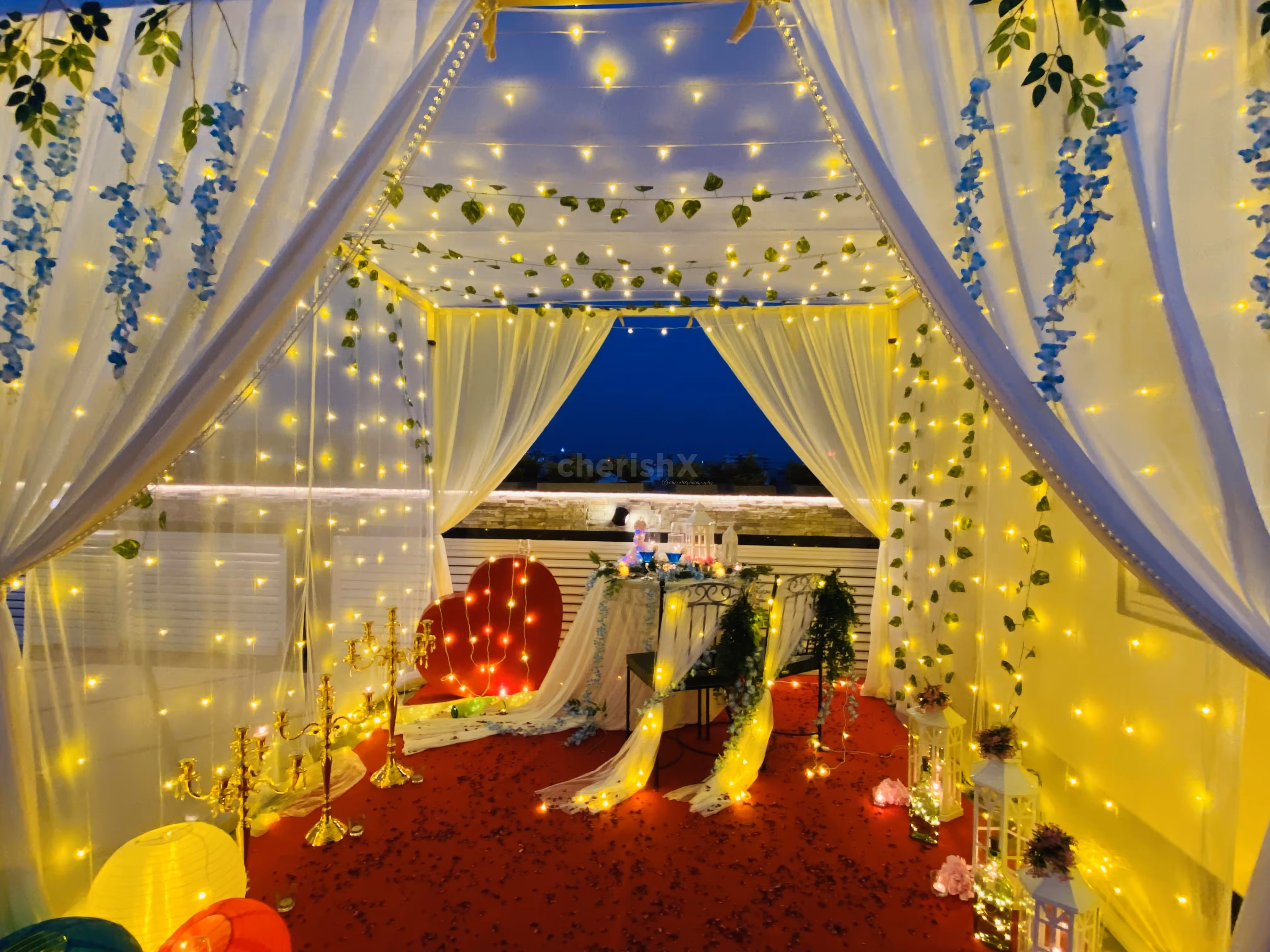 The table is beautifully adorned with a sea of delicate flower petals, creating a stunning visual spectacle.