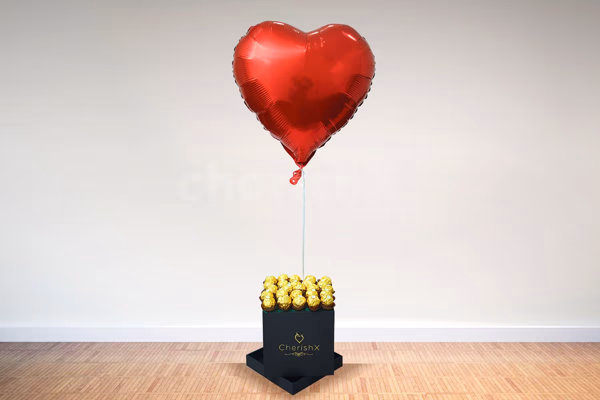 A box of happiness
in the form of chocolates and a heart-shaped balloon.
