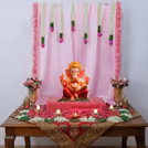 Pink Ganpati decoration with artificial flowers