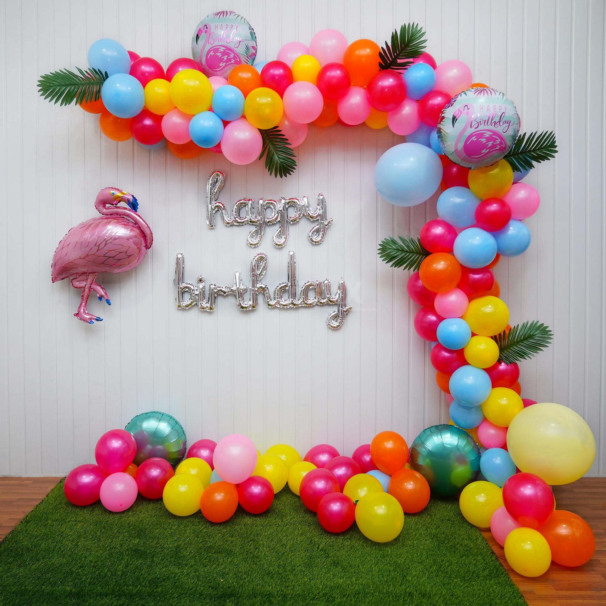 Step into a Flamingo Balloon Bliss Decoration, Where Vibrant Balloons and Palm Leaves Set the Scene.