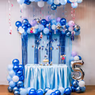 Frozen-themed balloon arch with bunting and toppers steals the party show