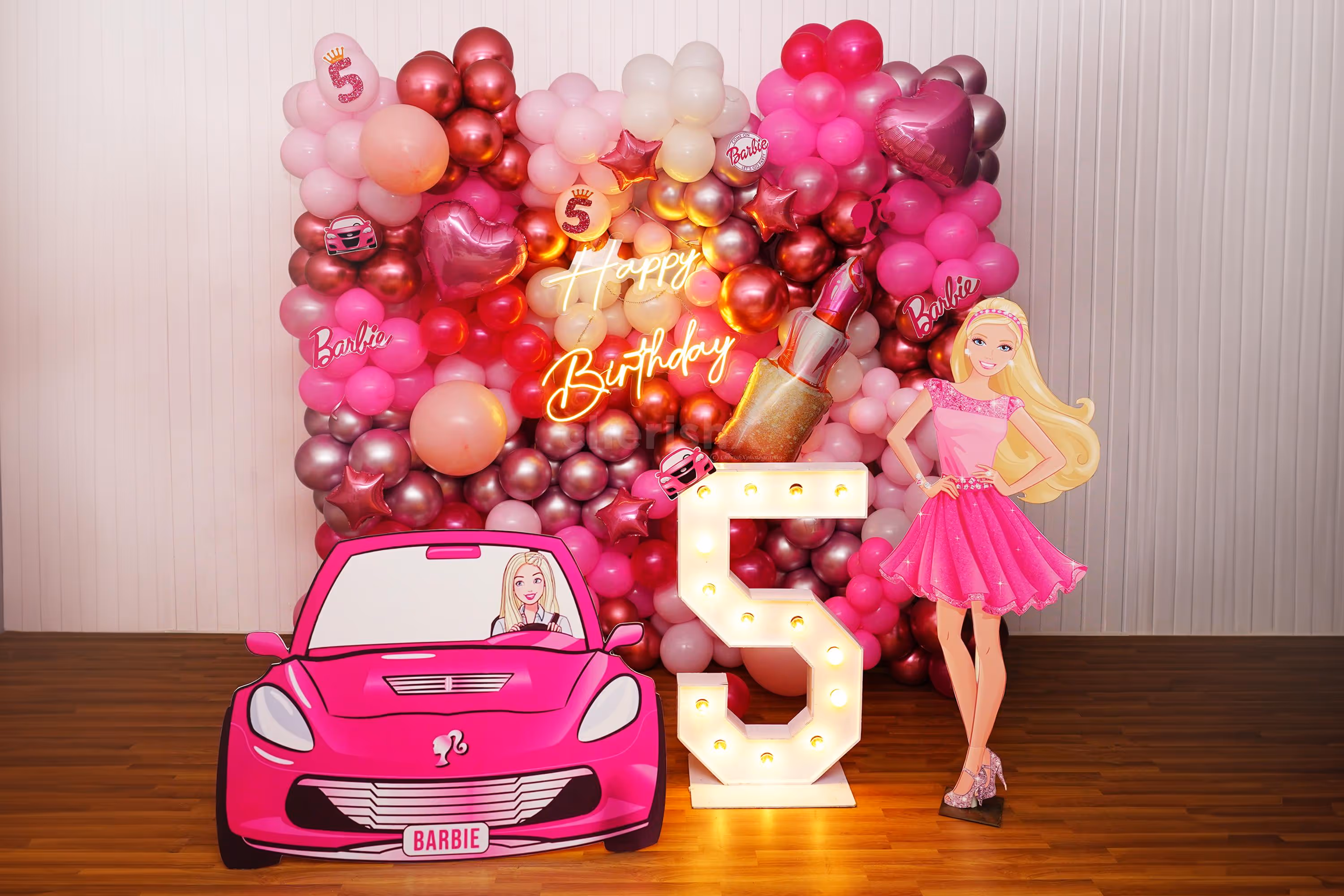 Mesmerizing balloon backdrop comes with pink, white, and magenta-coloured hues.