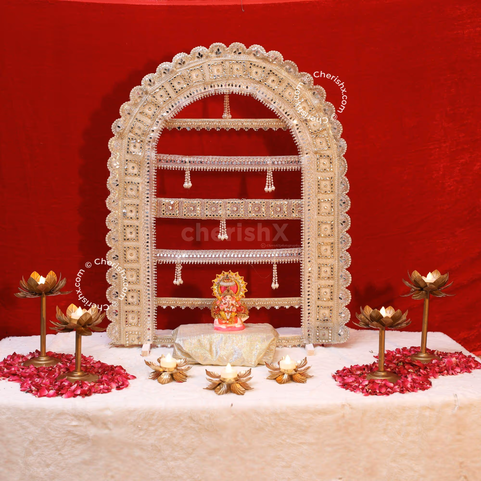 MDF Golden arc with intricate lace work and pearl tassels for Ganpati celebrations.