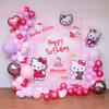 A colorful pastel balloon arch surrounds the Hello Kitty backdrop.