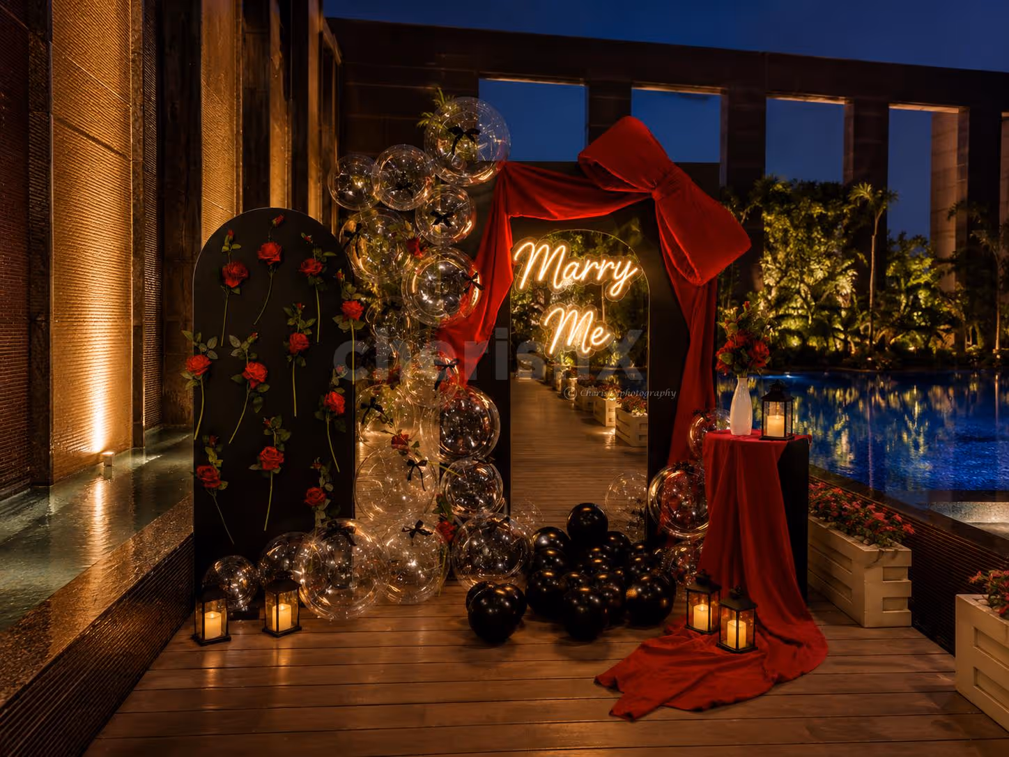 Big Red Bow Decorated With Glowing "Marry Me" Sign And Bubble Balloons