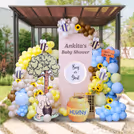 Rustic crate wall with pastel balloons and honeybee charm.