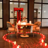 A romantic private courtyard setup with candlelight and floral decor
