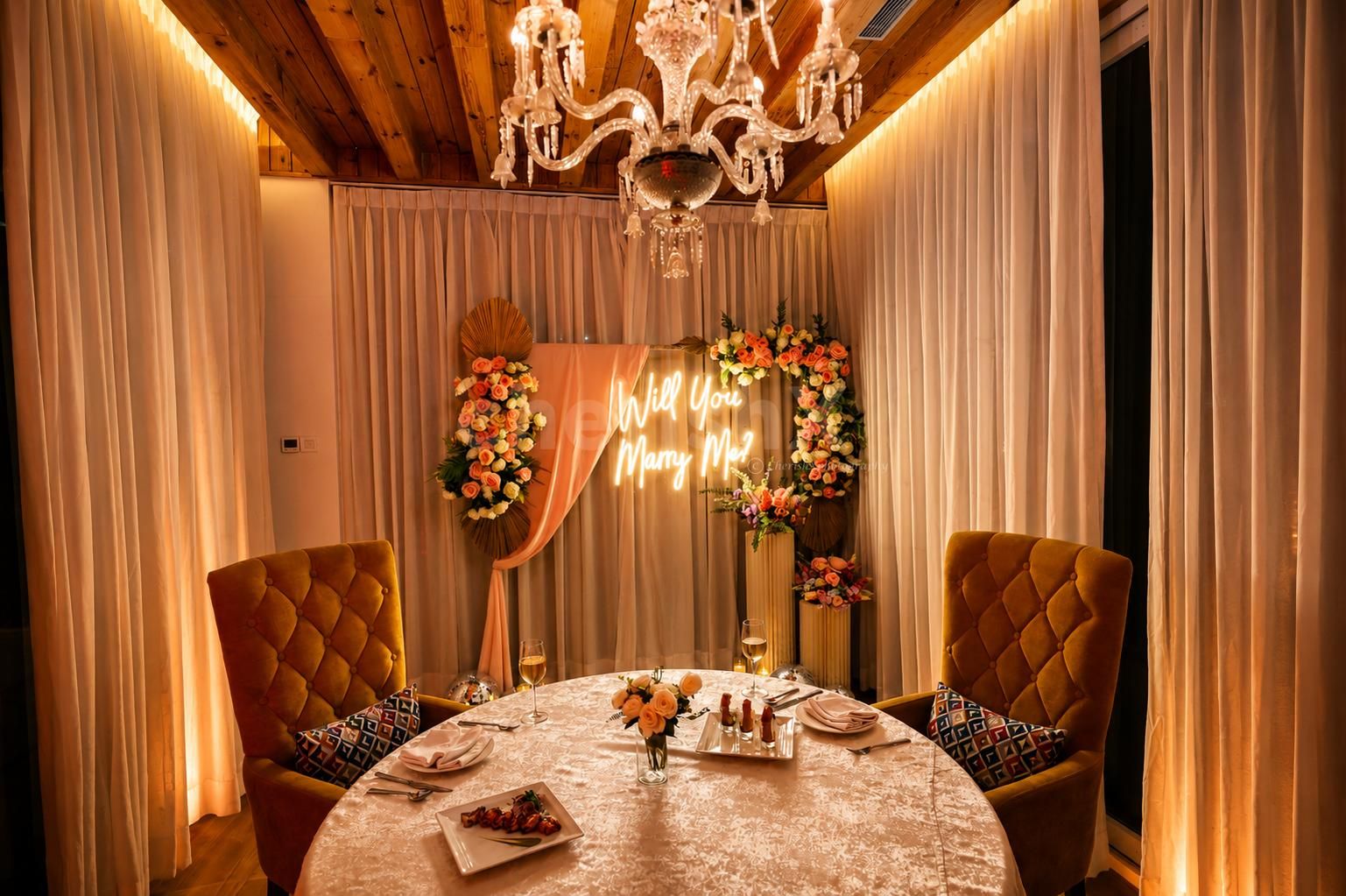 Elegant indoor proposal backdrop with floral decorations, glowing neon proposal sign, candles, and decorative mirror balls for a romantic celebration