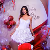 Red velvet draping fabric in the backdrop of the decor looks very appealing.