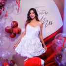 Red velvet draping fabric in the backdrop of the decor looks very appealing.
