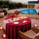 Romantic poolside candlelight dining by Hilton Gurgaon decorated by CherishX