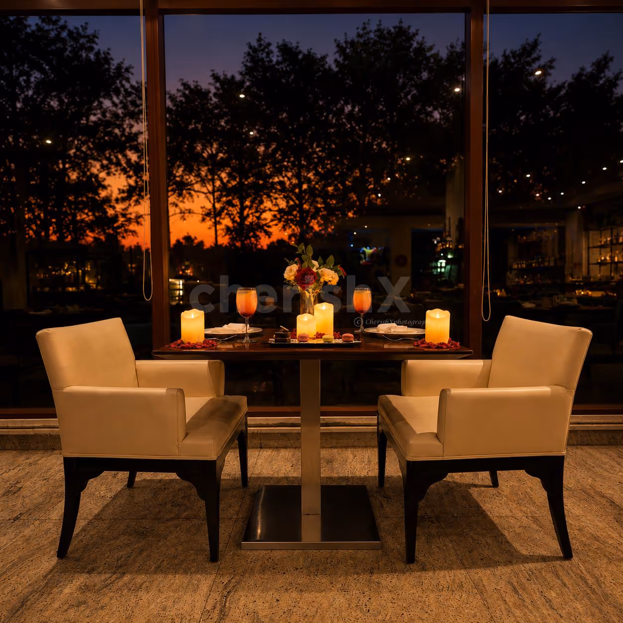 Romantic candlelight dining experience at Four Points by Sheraton featuring elegant table décor, floral arrangements, candles, and a cozy restaurant ambiance.