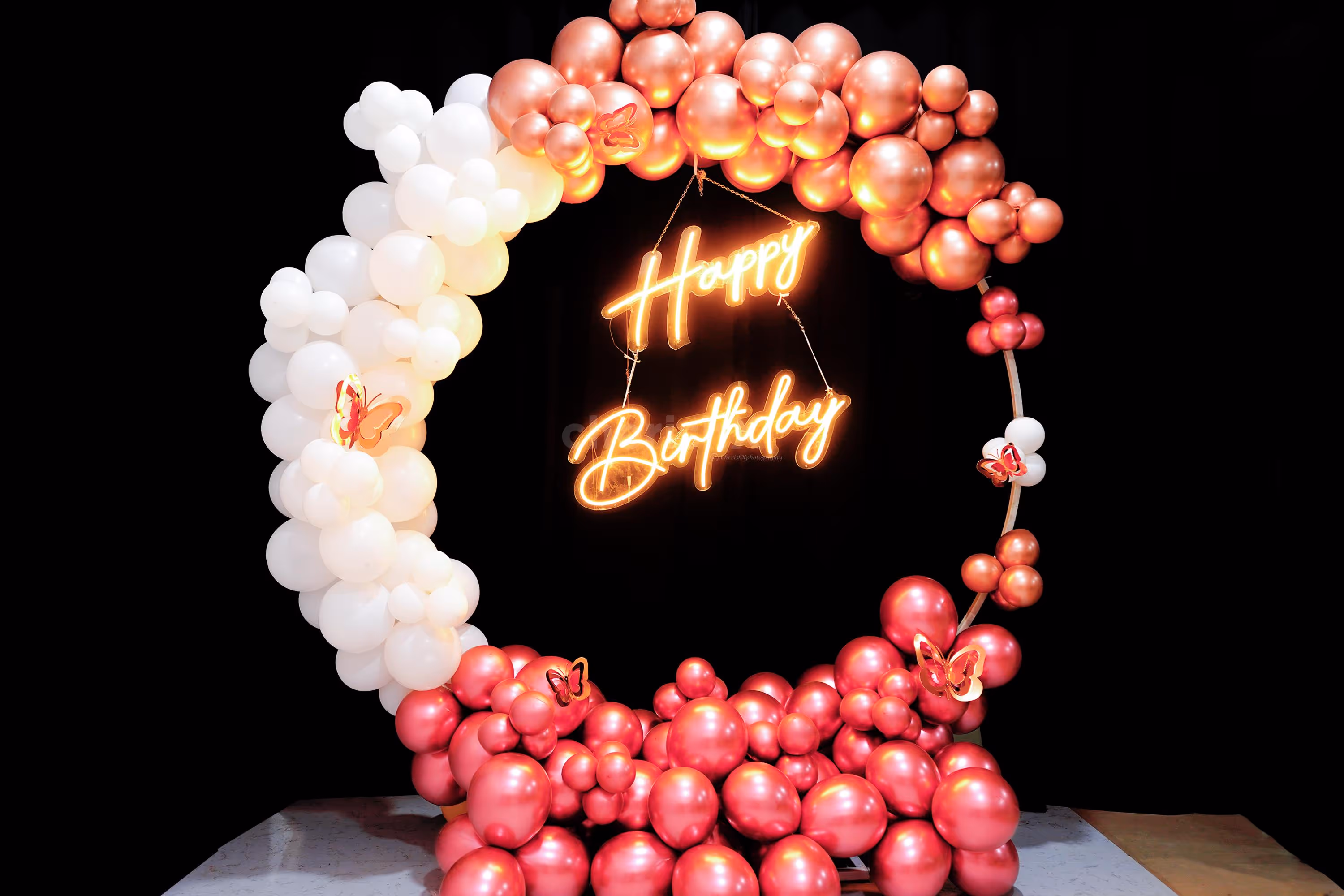 Add a touch of magic to your special day with our stunning rose gold and white balloon backdrop.