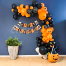Multicolored balloons, bunting, and flying bat details celebrate Halloween spirit.