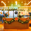 Wreath, gift boxes and star lights brighten up the office reception area for the celebration