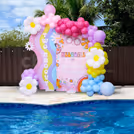Pastel balloon arch making spot-on poolside ambiance.