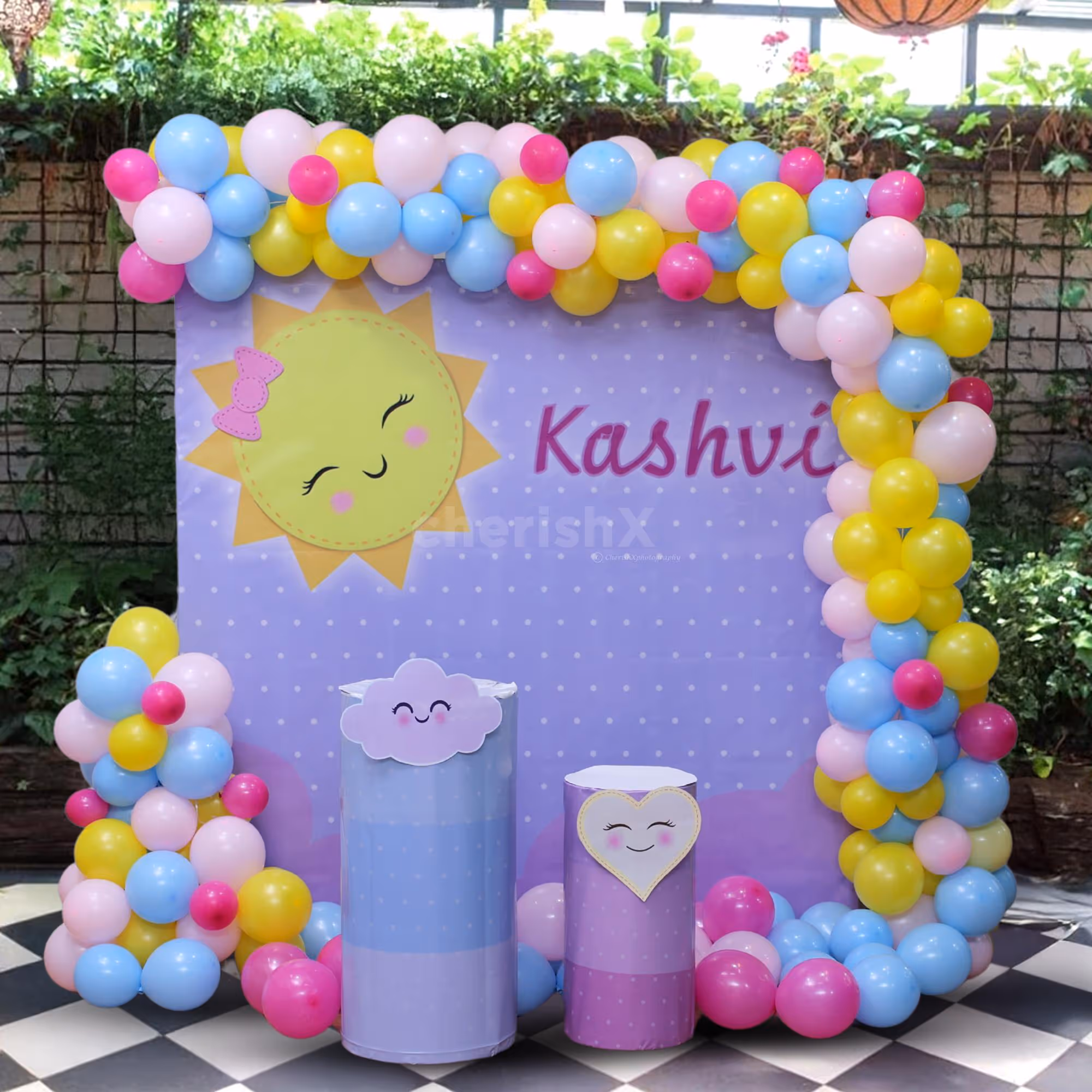 Pastel balloon entryway in bright sunshine theme.