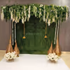 Wattle leaves add natural texture to the green wall decor, adding warmth