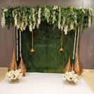Wattle leaves add natural texture to the green wall decor, adding warmth