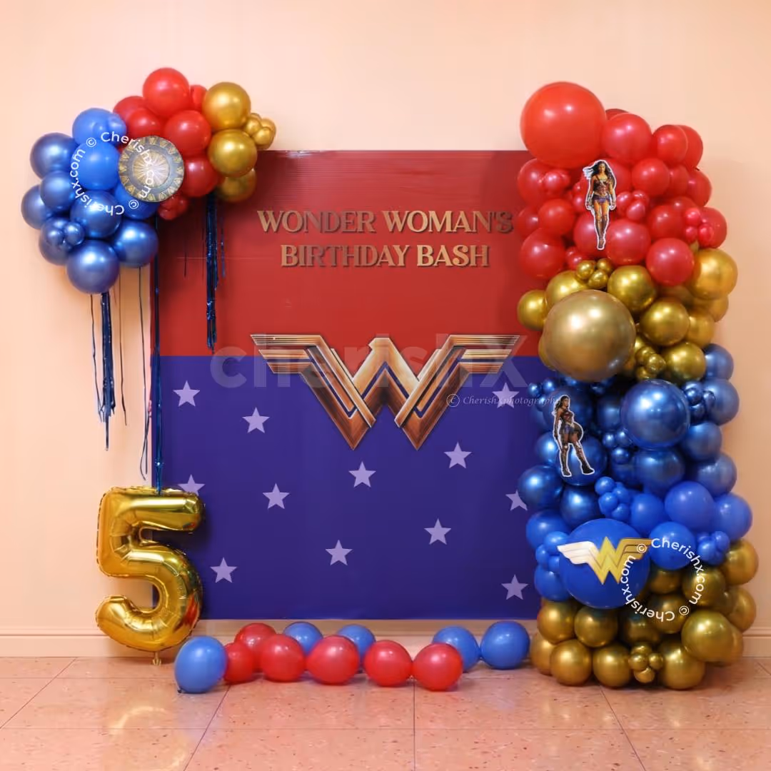 Wonder Woman birthday flex with red, blue and golden clusters of balloons and a golden age foil balloon.