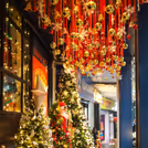Ceiling lighting, golden ball and bells with red ribbons enhance the glamour of the ceiling