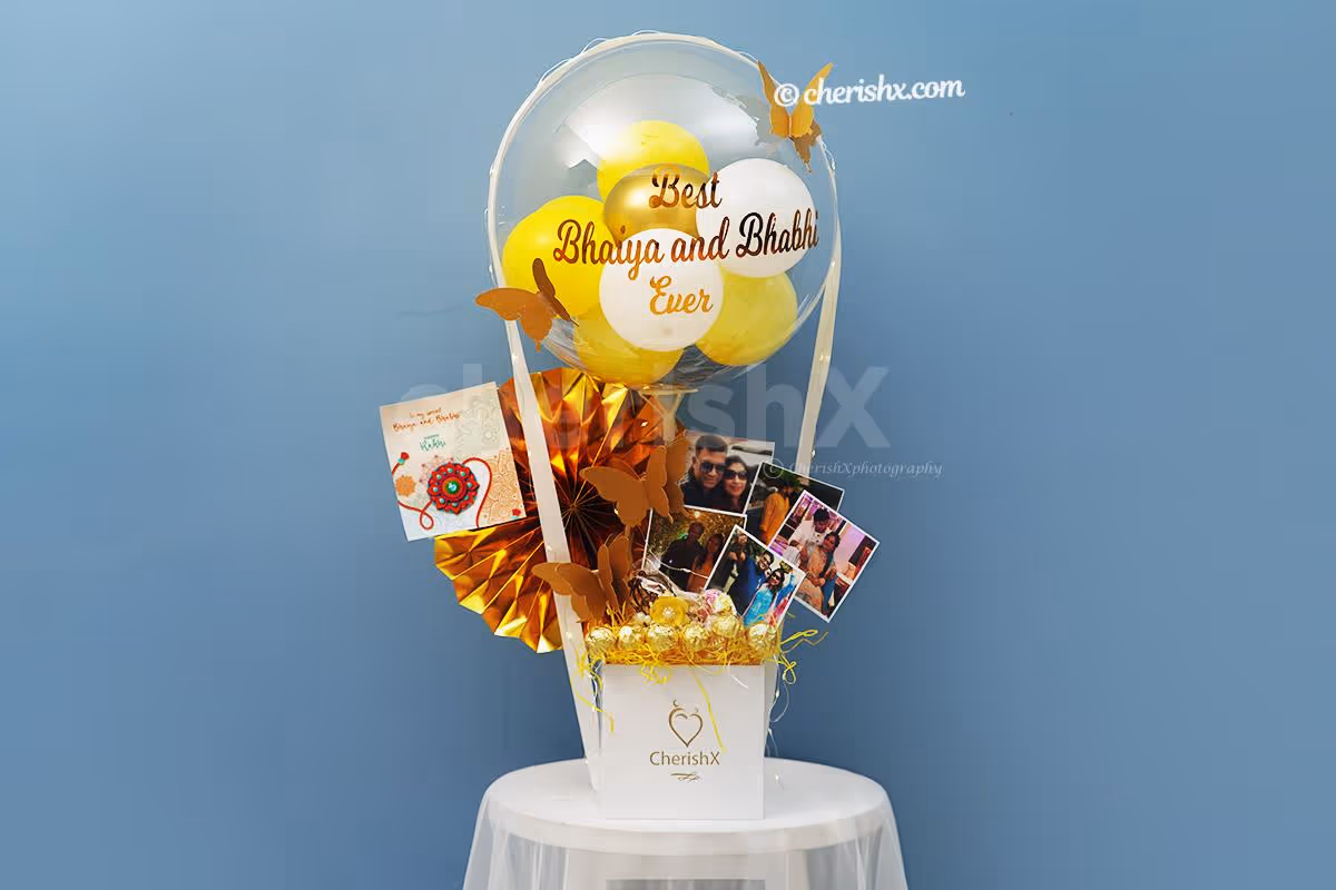 A Bubble balloon filled with yellow, pastel yellow, white latex and golden chrome balloons with a Golden Butterfly on it.