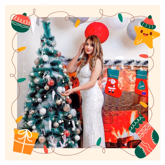 Captivating Christmas decor showcased with a woman posing next to a sparkling Christmas tree display