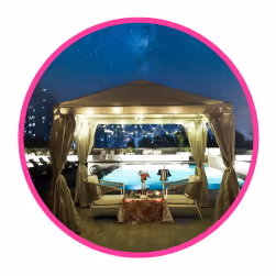 Romantic under the stars candle light dinner setup on rooftop.